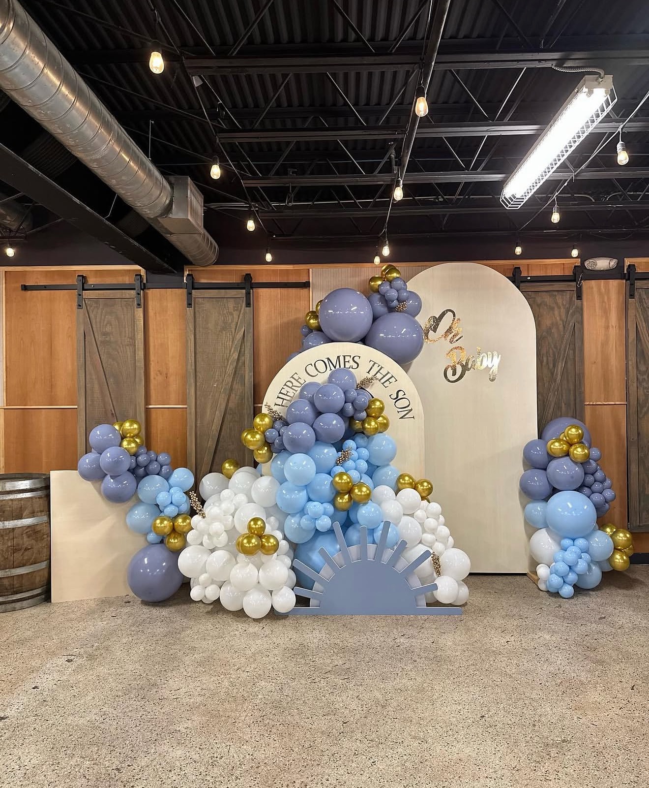 Baby shower backdrop with blue and white balloons and wood background